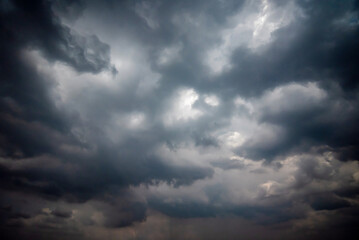 Fototapeta premium Dark and Moody Thunderstorm Clouds Forming in the Sky Before Heavy Rainfall and Severe Weather, Dark sky with stormy clouds,Dark clouds before a thunder-storm,clouds before rain