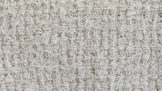 Knitted textile background with soft wool weave surface or abstract natural fabric cotton texture, neutral cozy material seamless clothes pattern.
