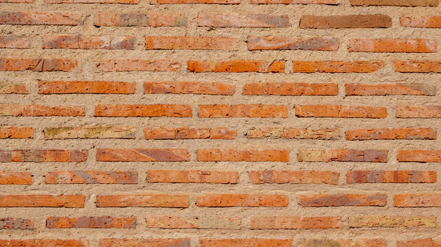 Textura de pared de ladrillo naranja con juntas de cemento