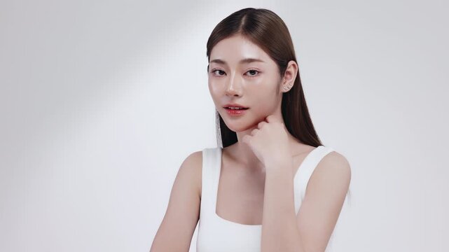 Slow motion of beautiful young Asian girl with k-beauty make up style on isolated white background for commercial beauty advertising.