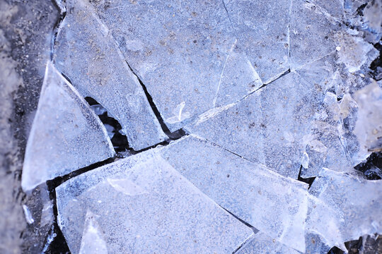 Crashed ice concrete surface background texture. Frozen ice surface of a lake in sunset