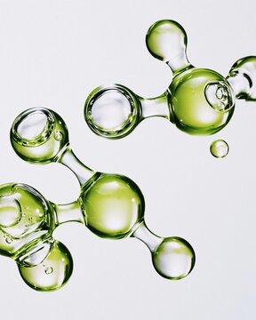 Transparent glossy green connected molecular structure on clean light background representing natural science cosmetics and organic skincare molecule concept