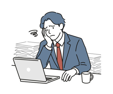 山積みの書類とノートPCの前で頭を抱えて悩む男性ビジネスパーソン（疲労・残業・過重労働）