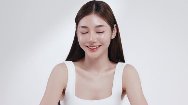 Slow motion of beautiful young Asian girl with k-beauty make up style on isolated white background for commercial beauty advertising.