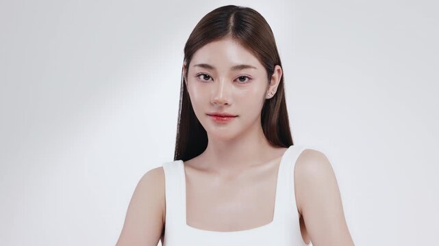 Slow motion of beautiful young Asian girl with k-beauty make up style on isolated white background for commercial beauty advertising.