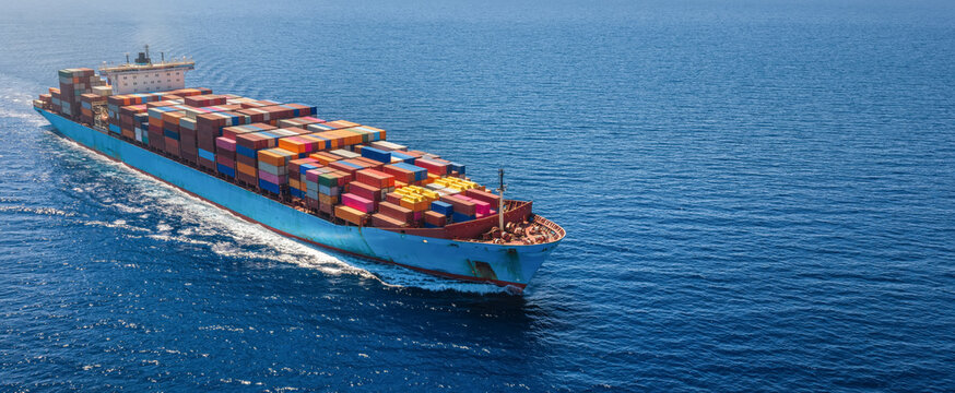 Aerial view of a super container cargo ship sailing over the ocean as a banner for transport and industry