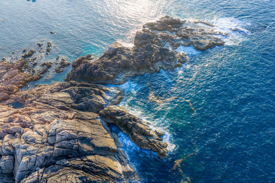 Panoramic aerial view of Nhon Hai fishing village, beach, and sparkling sea in Binh Dinh province, Vietnam