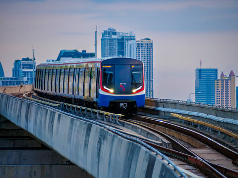 Bangkok, Thailand - July 8, 2026 :  The BTS Skytrain runs in and out of Ha Yaek Lat Phrao Station in the evening, offering views of office buildings and beautiful scenery.