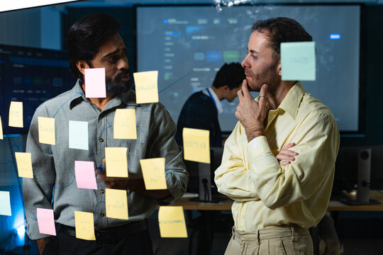 Software Engineers Team Collaborating on Project Planning with Sticky Notes, Reviewing Development Challenges, Prioritizing Technical Tasks and Discussing Software Implementation Strategy.