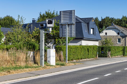 Wallonia, Belgium: Automatic speed camera unit installed along a residential street for speed enforcement and traffic safety monitoring.
