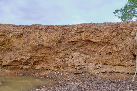 earth layers exposed under rainy sky mood