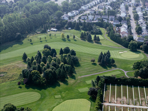 Aerial view of lush golf course near Laval Quebec Canada with ponds, trees and fairways. g.