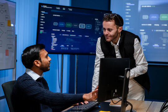Software Developers Troubleshooting Application at Computer Workstation, Reviewing Programming Code, Identifying Technical Issues and Working Together on Development Solutions.