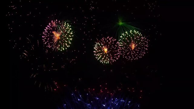 Colorful festive fireworks exploding in night sky celebration background