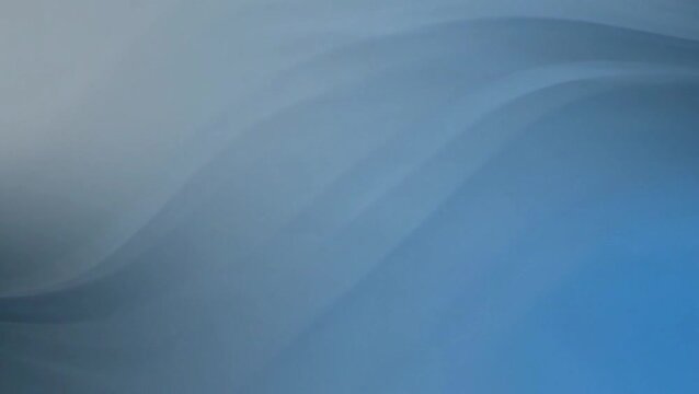 Abstract blue and grey gradient background with soft, flowing wavy lines creating a serene and modern visual effect.