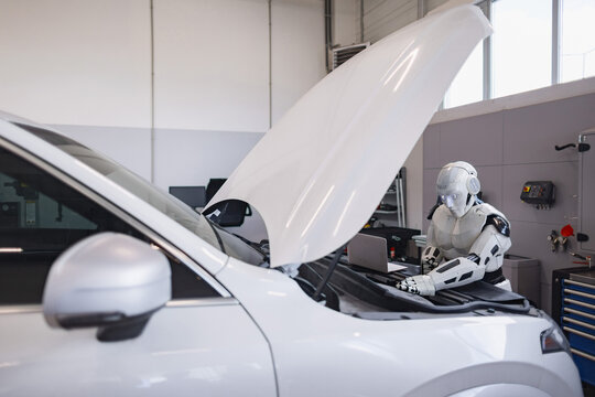 A humanoid robot is meticulously examining and repairing the engine of a modern vehicle in a well-lit garage setting