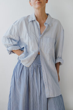 Casual Female Summer Outfit Featuring Loose Unbuttoned Light Blue Shirt And Matching Blue Skirt