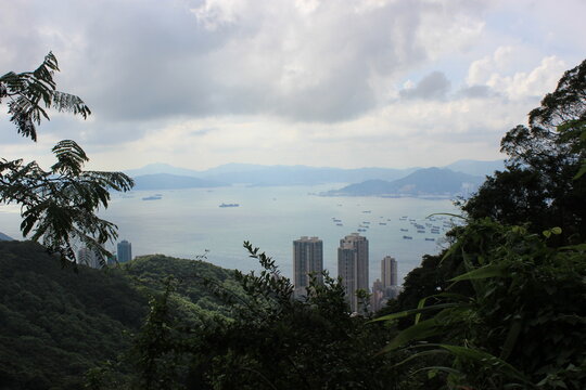 Hong Kong skyline and busy harbor viewed from Victoria Peak on a cloudy day