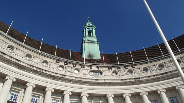 County Hall building with a green clock tower against a clear blue sky
