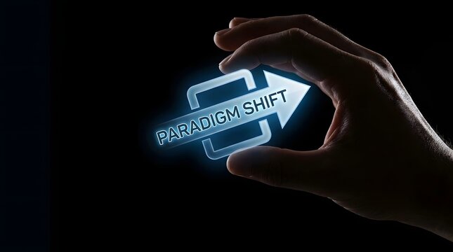 Human hand holding a glowing digital arrow icon with paradigm shift text