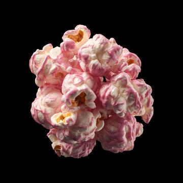 Pink glazed popcorn kernel cluster isolated on black backdrop, concept of sweet snack creativity and playful food art