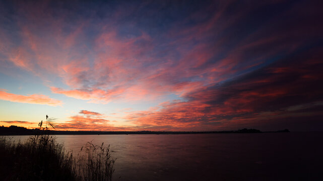 Vivid red winter sunset over lake