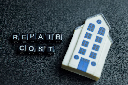Repair cost text stacked wooden cubes on the table