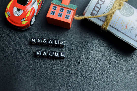 Resale value text stacked wooden cubes on the table. For potential profits in the car resale value market