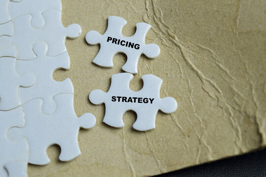 Piece of jigsaw puzzle pricing strategy phrase.