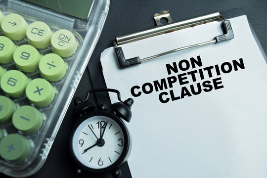 Concept of non competition clause write on clipboard isolated on table.