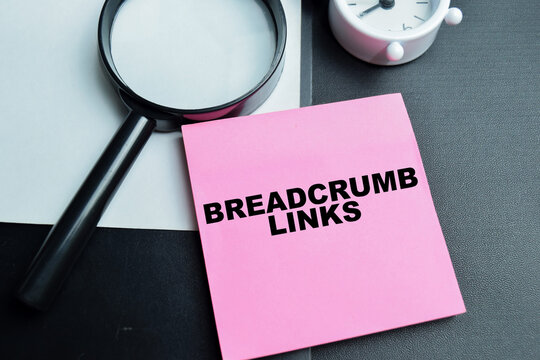 Concept of breadcrumb links write on sticky notes isolated on table.