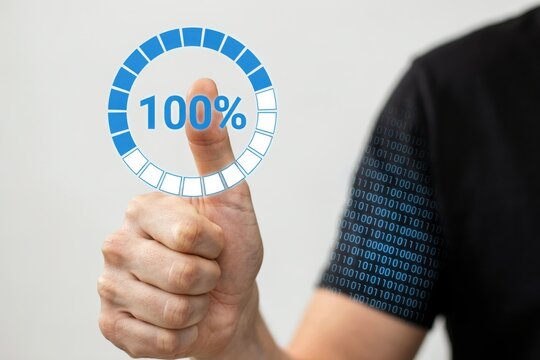 A person giving a thumbs up gesture next to a glowing one hundred percent loading progress circle with binary code. Perfect concept for technology success and complete digital.