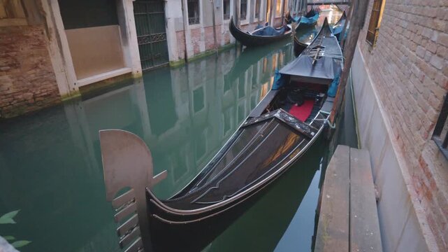 Gondolas Moored Along a Narrow Venetian Canal at Dusk