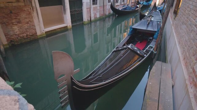 Gondolas Moored Along a Narrow Venetian Canal at Dusk
