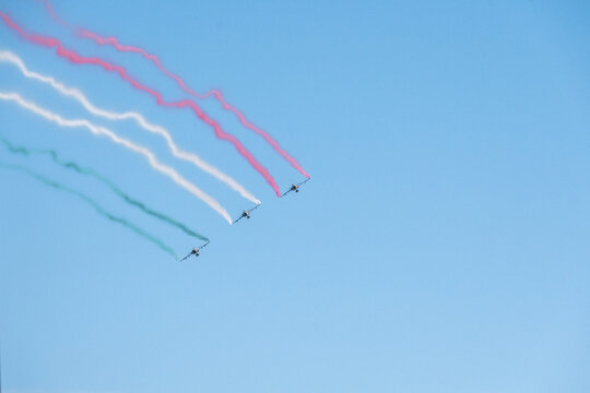 Three Aircraft Flying in Formation With Colored Smoke Trails