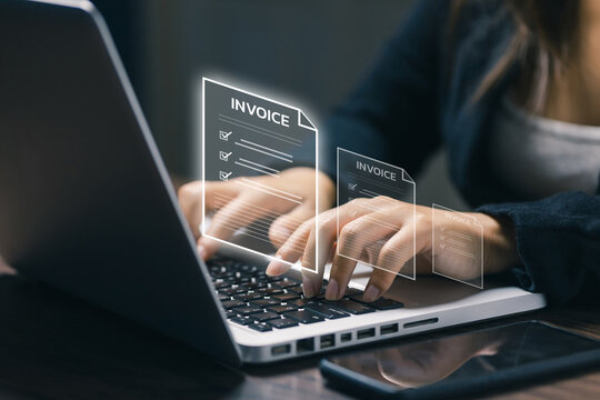 Businesswoman typing on laptop with virtual invoice documents, representing digital billing, online accounting, finance management, electronic payment, paperwork, workflow, and business.