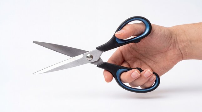 Person holding sharp metal scissors in their hand