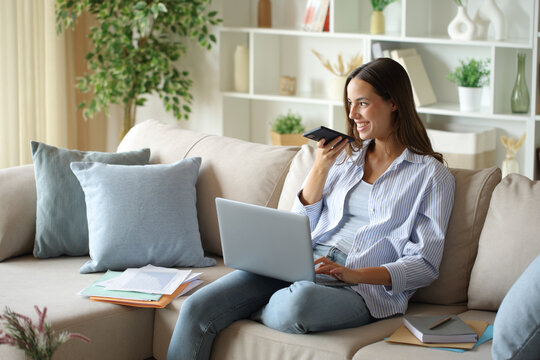 Teleworker using virtual assistant on phone working at home
