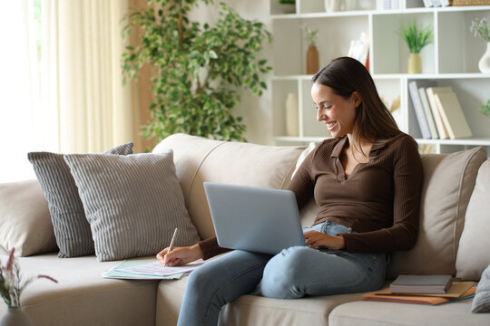 Teleworker on a sofa working filling out form