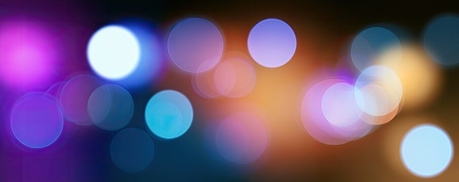 Out-of-focus circles of vibrant purple, blue, and orange light create a dreamy, abstract background