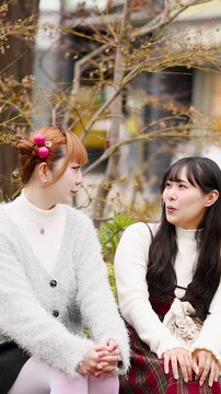 Two Young Japanese Women Talking and Laughing in Harajuku
