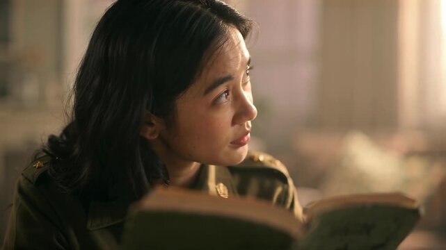 Young Woman Reading Book Indoors with Warm Lighting Cinematic Lifestyle Scene