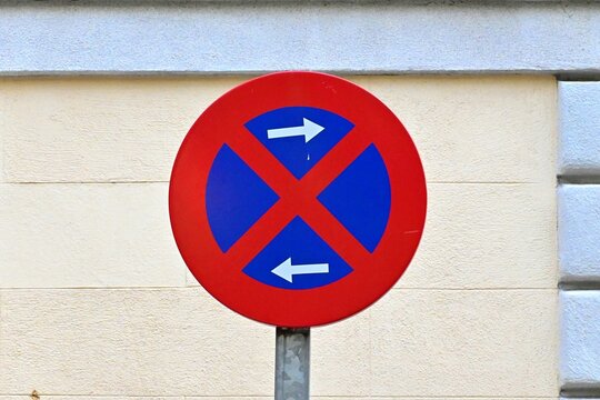 A road sign prohibiting standing and parking, in an urban environment in Madrid, Spain. August 12, 2026