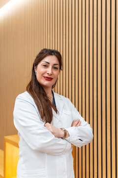 Female specialist in white coat standing at aesthetic clinic