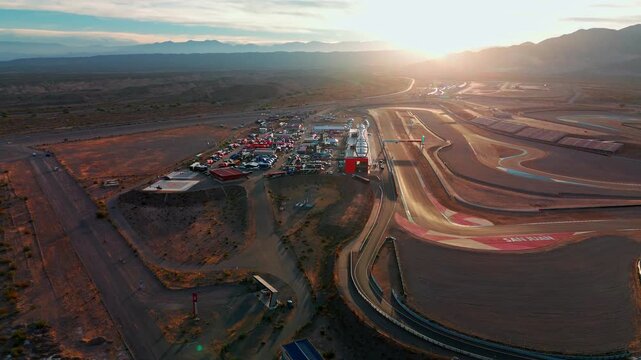 left side wide drone shot over Circuito San Juan Villicum in argentina during sunset with service park parc ferme