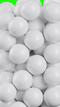 White golf balls falling on green screen background