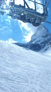 Vertical POV shot looking out from a descending cable car cabin window over groomed ski slopes toward the iconic cloud-covered Matterhorn summit in Zermatt.
