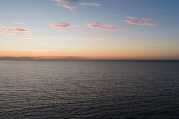 Fototapeta premium Aerial view of calm sea at dusk after sunset over Gulf of Finland Baltic sea