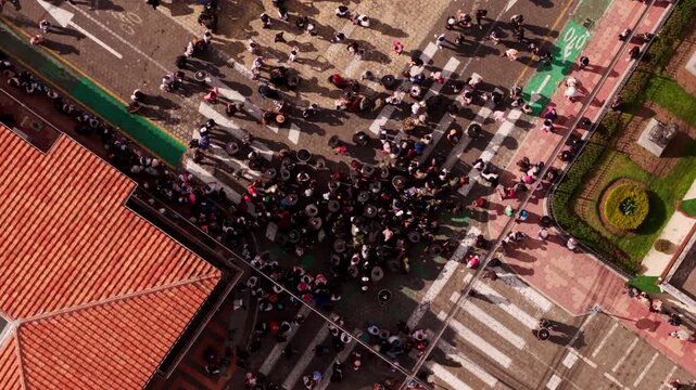 Aerial view of a crowded indigenous parade celebrating inti raymi on the streets of cotacachi