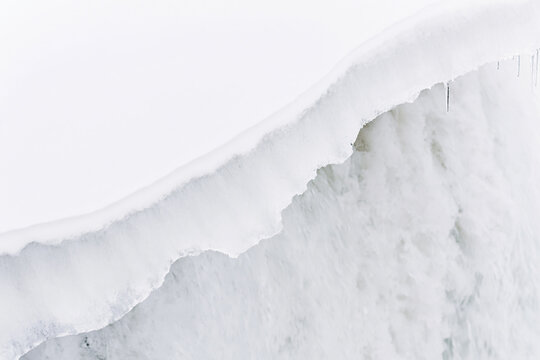 Abstract close up shot of melting ice and flowing water in winter